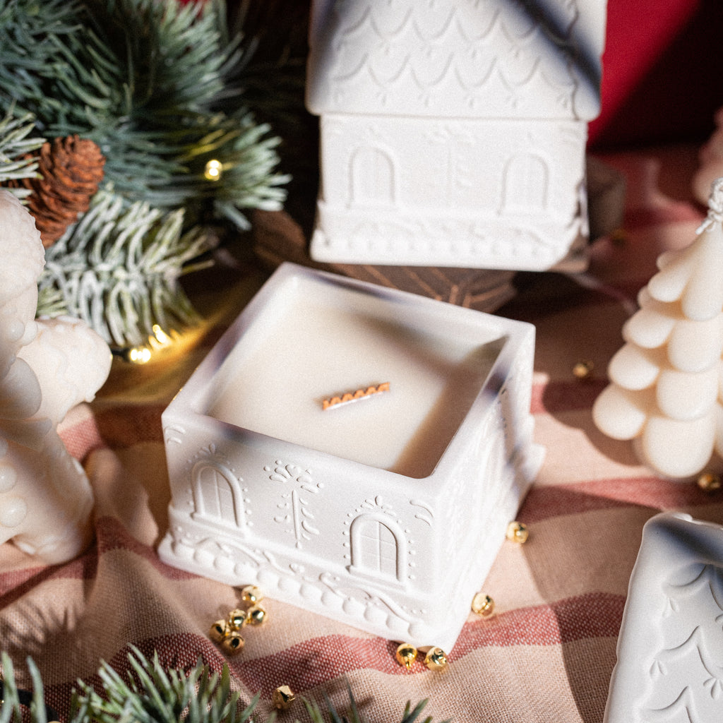 Seasonal Christmas candle designed as a gingerbread house crafted from gypsum