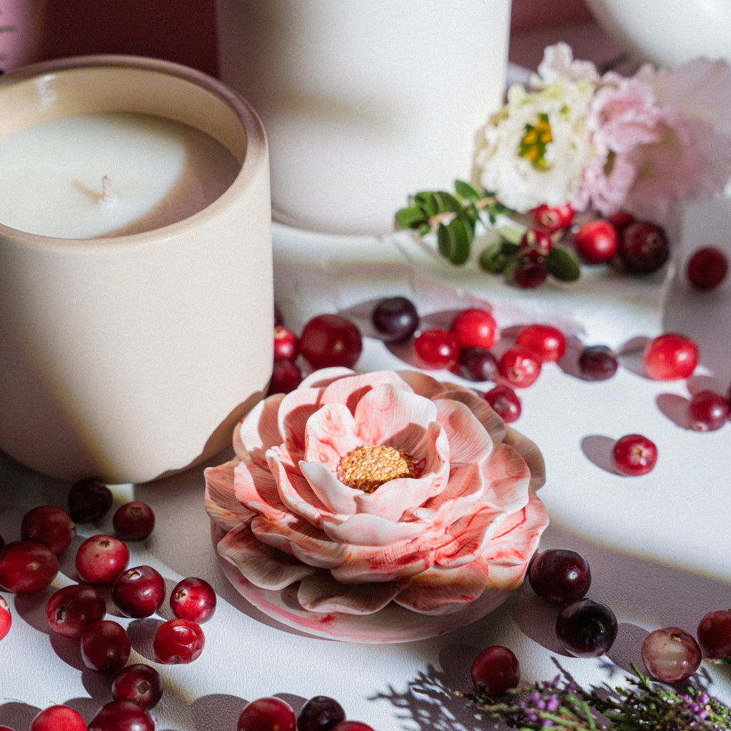 Cranberry and currant candle styled as cozy home decoration