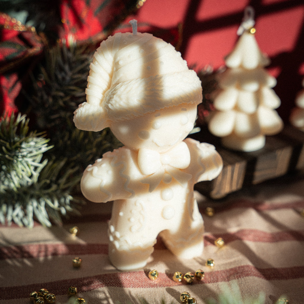 Handmade gingerbread man candle made from natural rapeseed wax with detailed decorations